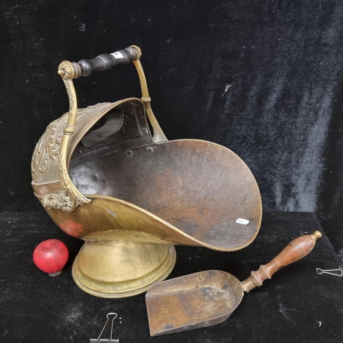 196 - A large antique 19th century brass coal bucket with shovel, boasting floral decoration and wooden ha... 