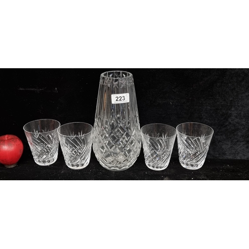 223 - Five Waterford Crystal items including a large vase and four tumbler glasses.