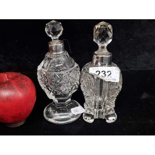 232 - Two elegant antique  hand cut glass perfume bottles with Sterling silver collars and original stoppe... 