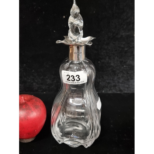 233 - A beautiful antique decanter bottle with sterling silver collar and original stopper.