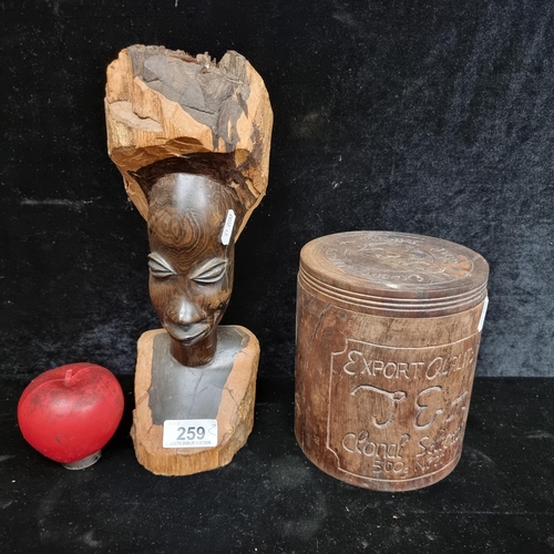 259 - Two wooden items including a large African tribal figure as well as a lidded wooden tea caddy.