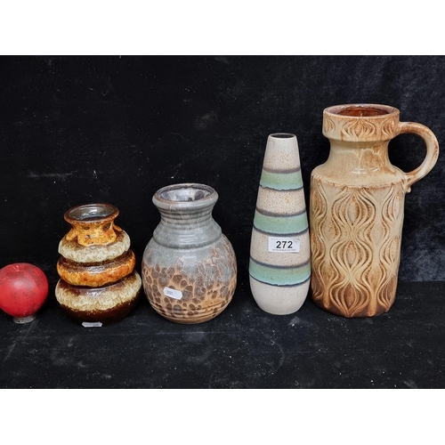 272 - Four mid century studio art pottery items including a large water pitcher jug and a tall bud vase.