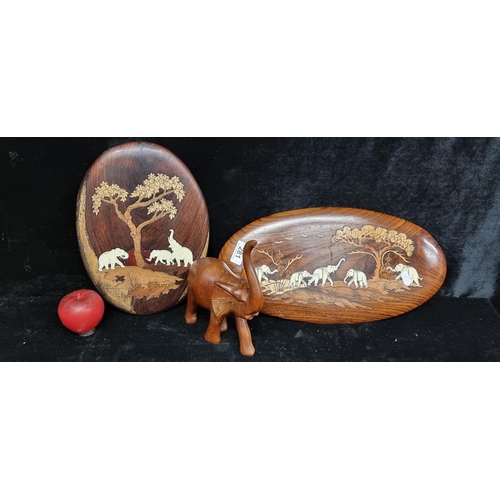 281 - A trio of carved African items including two intricated carved wall plaques with bone detail as well... 