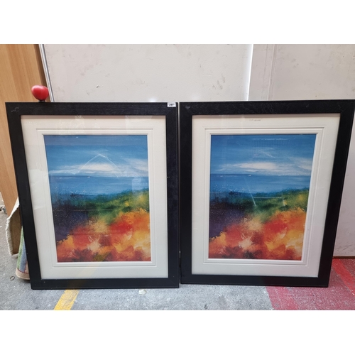 297 - Two very large high quality printed copies of a charming landscape painting showing fiery foliage in... 