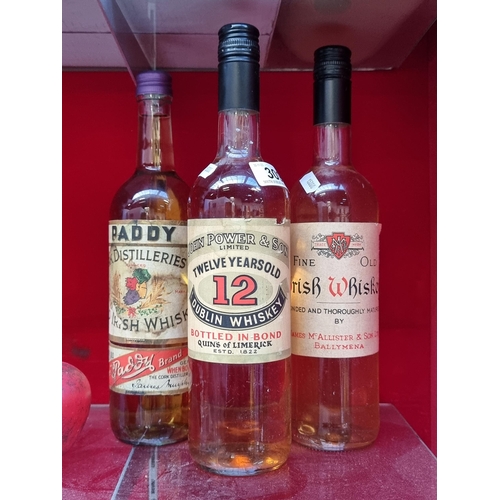 309 - 3 vintage Irish Whiskey bottles from John Power, Paddy and James McAllister & Son. Contains coloured... 