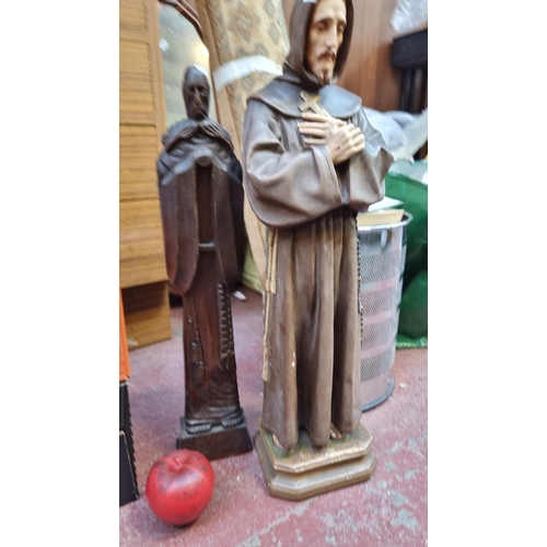 331 - Two religious statues of Saints including a carved wooden example and a cast plaster example.