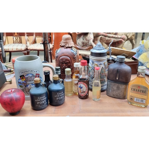 341 - A box of drinks items including a highly unusual moulded leather bound Mongolian Vodka bottle, Two G... 