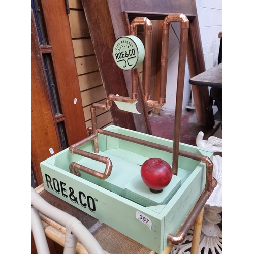 357 - A vibrant Roe & Co. Whiskey display stand and tray with copper pipe detailing and a turquoise finish... 