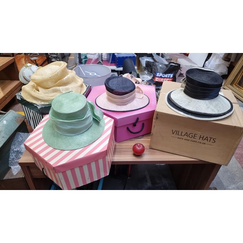 372 - Four stylish ladies' hats in various shades and styles accompanied by hat boxes. Boasting ribbons, f... 