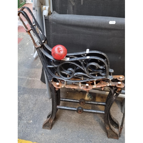 388 - An elegant pair of antique cast iron  bench ends boasting a foliate scroll motif. Comes with connect... 