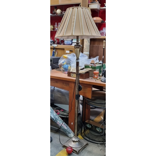 394 - A striking floor-standing lamp with Neoclassical style elements including urn to metal stem and foli... 