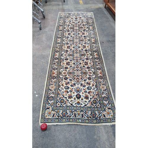 728 - Star Lot : A lovely hand knotted wool hall runner rug in shades of cream and baby blue. L298cm x W96... 