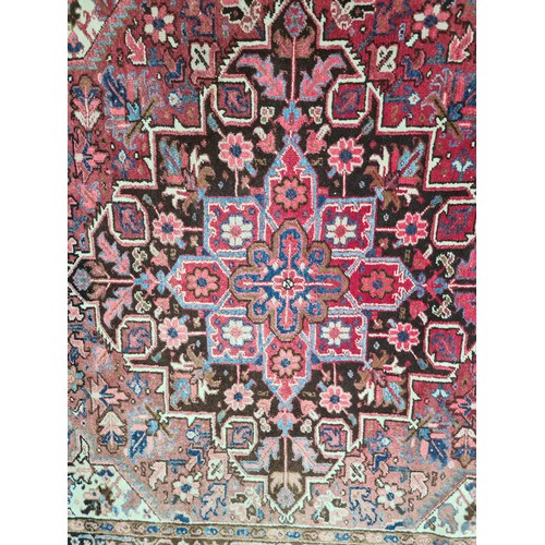 733 - Star Lot : A very large hand knotted wool rug boasting a floral and geometric design. L290cm x W212c... 