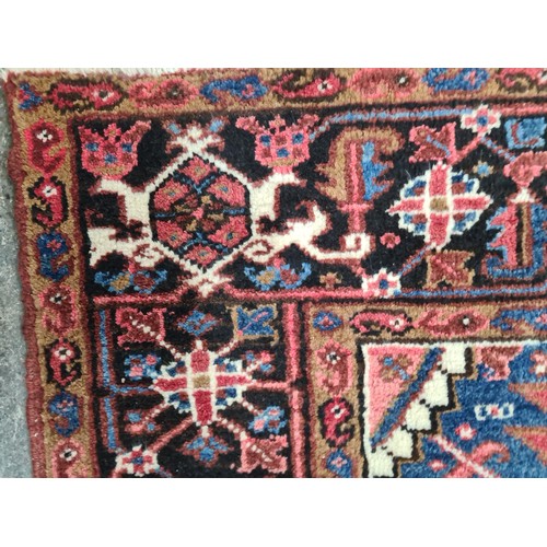 733 - Star Lot : A very large hand knotted wool rug boasting a floral and geometric design. L290cm x W212c... 