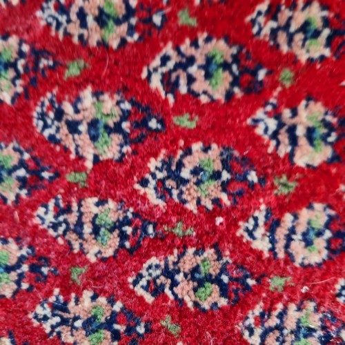 732 - Star Lot : A huge gorgeous hand knotted wool rug in a ruby red shade with an intricate geometric and... 