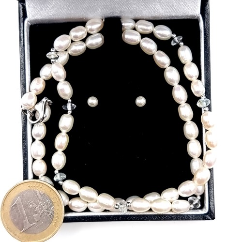 594 - A fine quality oval shape natural fresh water pearl necklace set with crystal bead accents with ster... 