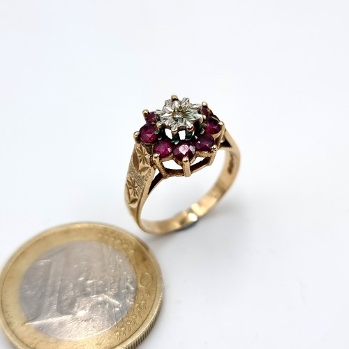 588 - Star lot : A super fine example of a 9K gold diamond and ruby floral set ring on a crown raised moun... 