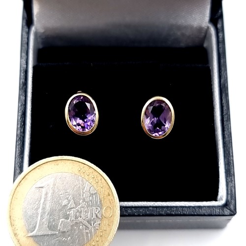 593 - Star Lot : A pair of vintage 9K gold amethyst stone stud earrings, weight 2.2 grams