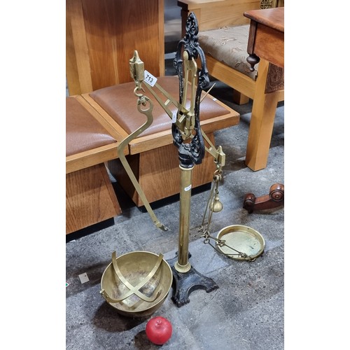 713 - An ornate large vintage floor standing weighing scales expertly crafted from  cast iron and brass.