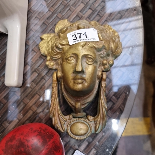 371 - An ornate Antique heavy  brass door knocker depicting a classical mask.