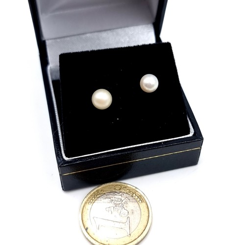 602 - A pair of 9K gold pearl stone earrings.