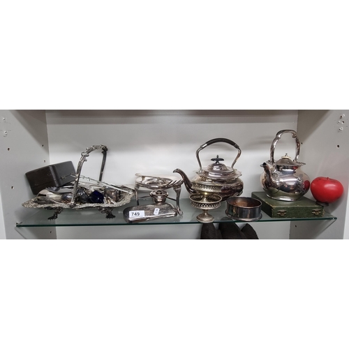 749 - A large collection of vintage silver plate items including two teapots and a selection of tableware.