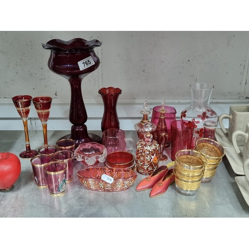 765 - A large impressive collection of ruby glass including shot glasses and candlesticks.