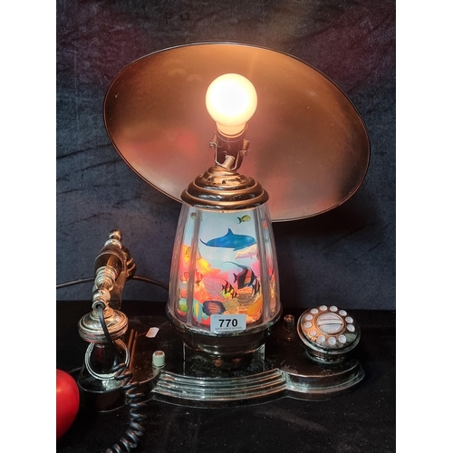 770 - A retro revolving tropical dolphin table lamp and telephone.