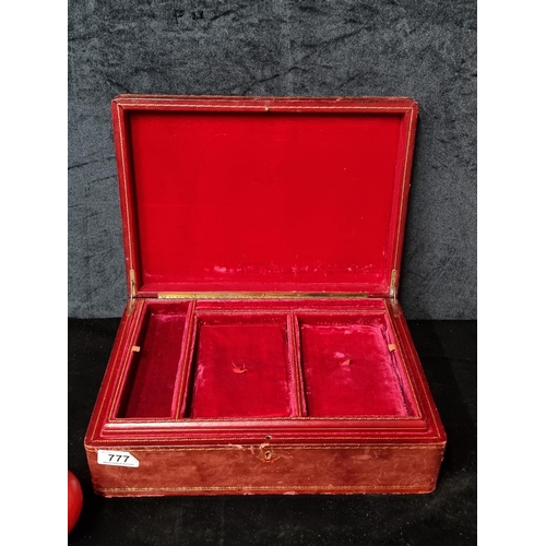 777 - A beautiful red and gold leaf embossed leather bound jewelry box with red velvet interior.