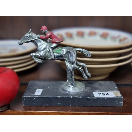 794 - A cast metal sculpture of horse and jockey With hand painted detail and marble base  nice looking pi... 