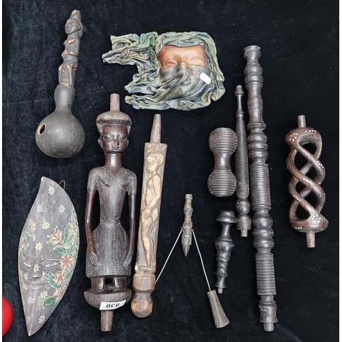 830 - A collection of hand carved African wooden objects including some figurative examples. Of particular... 