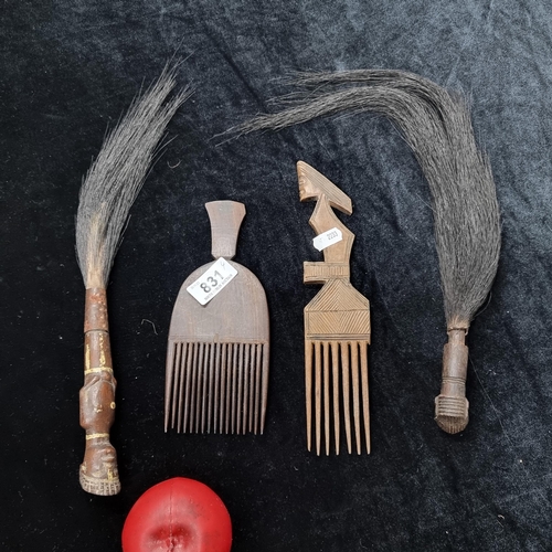 831 - Two hand crafted African elephant hair fly whisks, with carved wooden figurative handles, along with... 