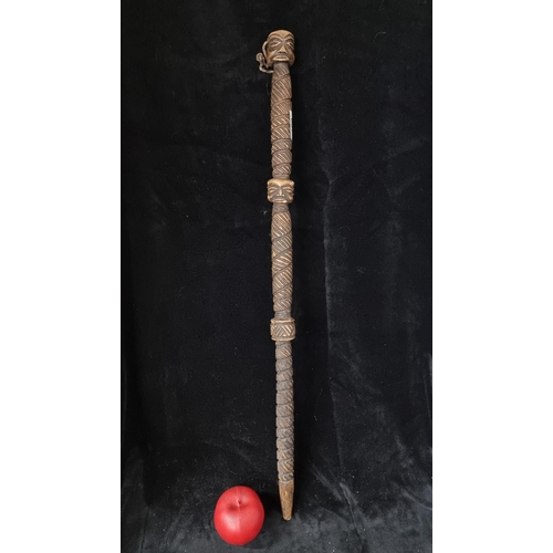 837 - A vintage hand carved African wooden cane featuring three bosses, two of which have faces carved int... 