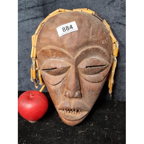 884 - An antique tribal hand carved African Chokwe mask, originating to Angola. The mask depicts a young w... 