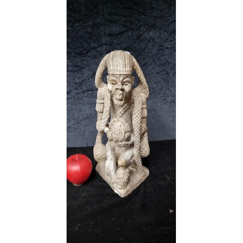 889 - Star Lot : A Kissi very heavy stone/marbel pombo sculpture of a village elder. This enigmatic figure... 