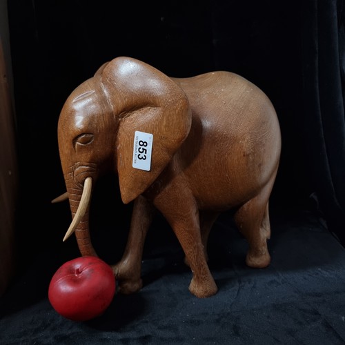 853 - A beautiful and very heavy hand carved African wooden sculpture of a gentle elephant carved from tea... 