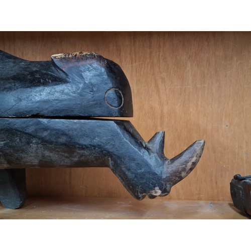 877 - A large beautifully carved African serving trough in the form of a rhino. missing one leg. Top remov... 