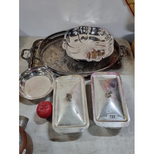 722 - A selection of 7 vintage silver plated serveware items including two large trays with elaborate etch... 