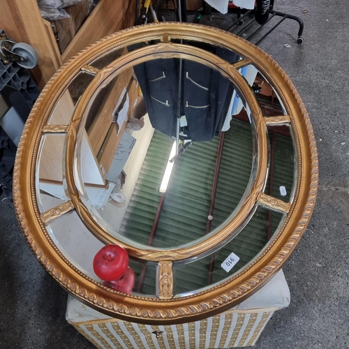 910 - Star Lot : An exquisite very large oval mirror with elaborate gilt frame and bevelled mirror panels.