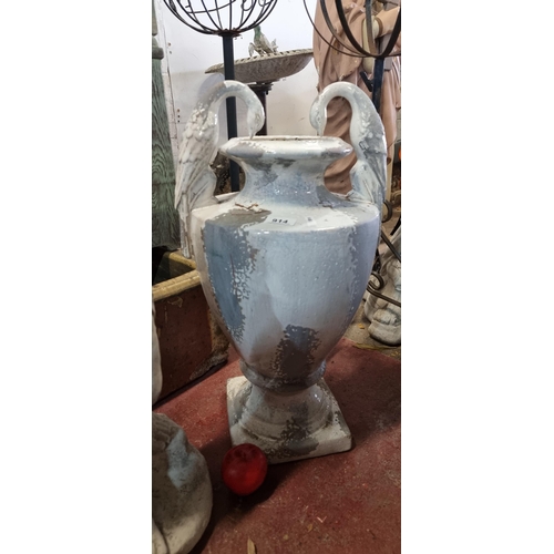 914 - A large and heavy plaster garden urn featuring two handles in the form of elegant birds. In a stylis... 