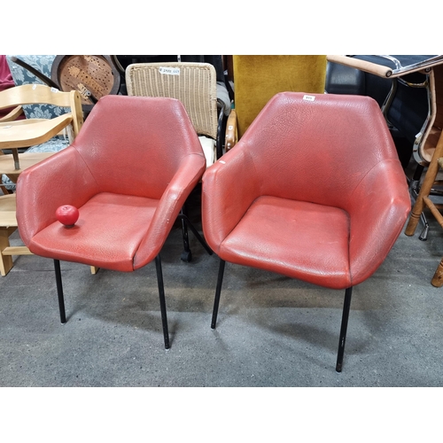 915 - A pair of stylish mid century  red leather chairs with black metal legs. A very cool modern aestheti... 