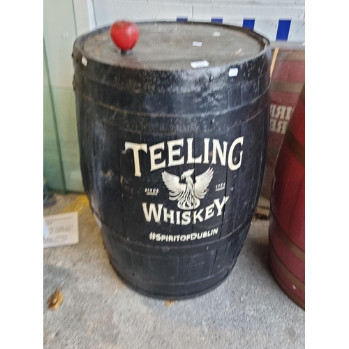 947 - A full size Teeling Whiskey wooden barrel with metal banding. Ideal for use in a pub.