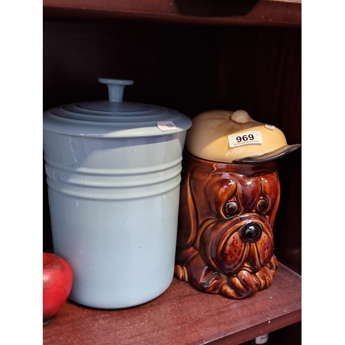 969 - Two charming ceramic biscuit jars, including a Le Creuset example along with one in the form of a sa... 