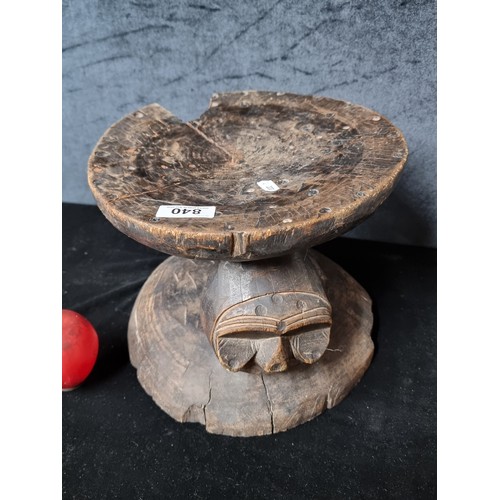 840 - A wonderfully heavy wooden hand carved African stool with face motifs to both sides.