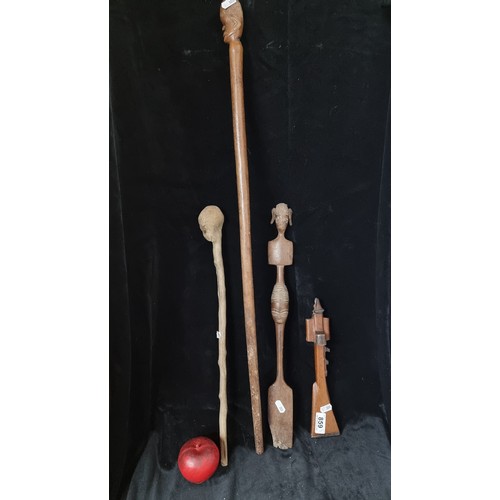 859 - A collection of four hand carved African wooden items including a wonderful knobkerrie, originating ... 