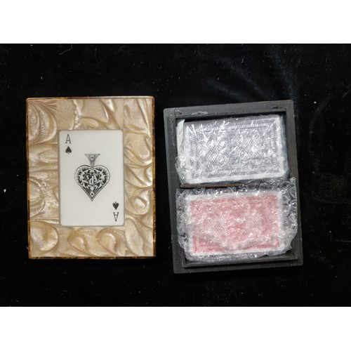 176 - Three items including an elegant card box with mother of pearl effect design and two packs of new ca... 