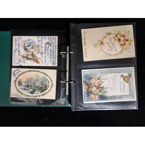 186 - A postcard album containing a large collection of approx. 156 antique and vintage Christmas postcard... 