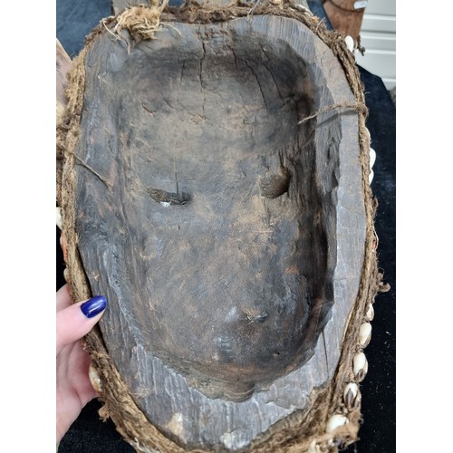 829 - Star Lot : A very large antique hand carved African wooden mask featuring large angular facial featu... 