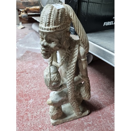 889 - Star Lot : A Kissi very heavy stone/marbel pombo sculpture of a village elder. This enigmatic figure... 