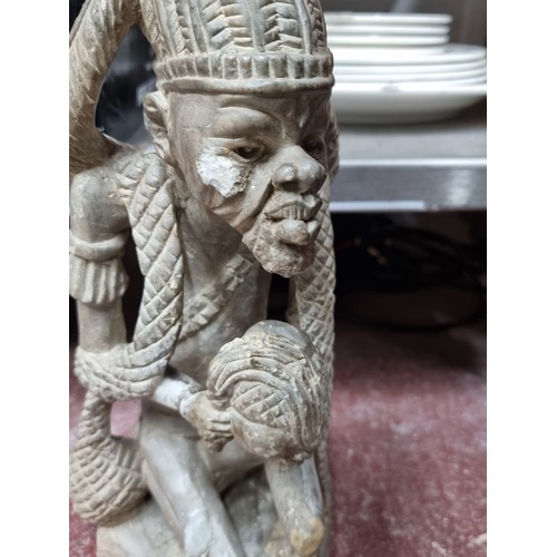 889 - Star Lot : A Kissi very heavy stone/marbel pombo sculpture of a village elder. This enigmatic figure... 